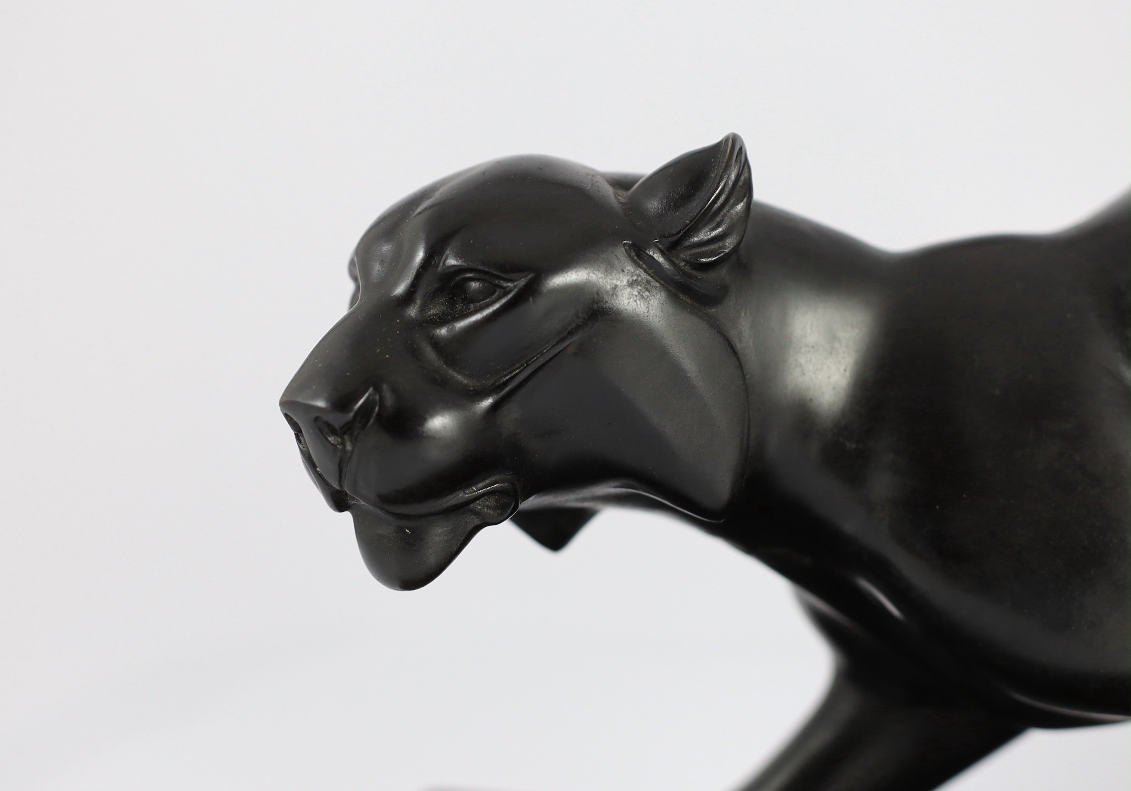 Irene Rochard. A French Art Deco bronzed spelter and marble model of a black panther, 44cm wide, 27cm high